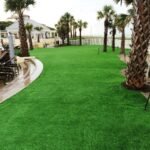 Synthetic lawn beside the pool deck lounge chairs at Omni Amelia Island Resort