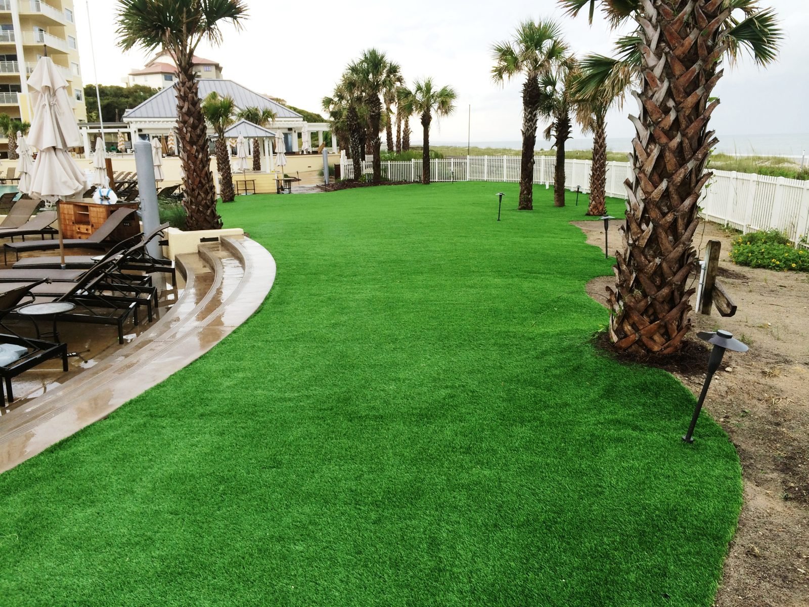 Synthetic turf lawn beside a resort pool deck at Omni Amelia Island